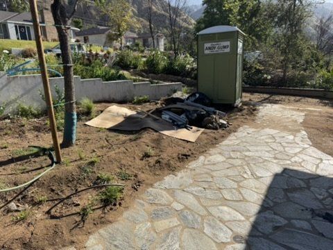 Altadena construction site with flagstone walkway and materials for rebuild with dual rain gardens
