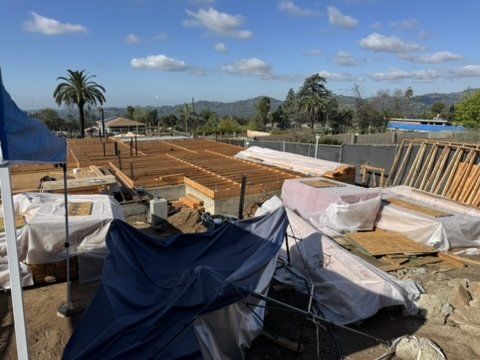 Altadena construction site showing floor joists on foundation with area drain placement for stormwater management
