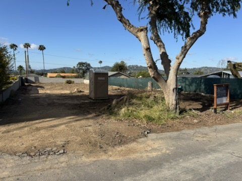 Altadena construction site featuring existing tree preservation and natural grade for drainage design