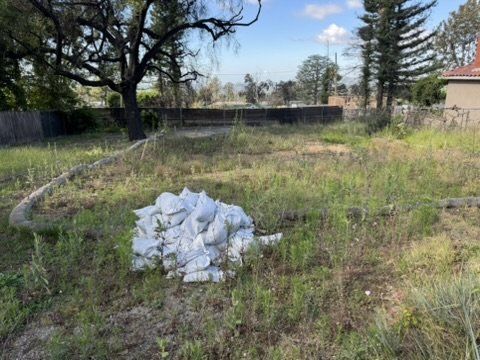 Altadena corner lot with erosion control measures and sandbags prepared for drainage plan installation