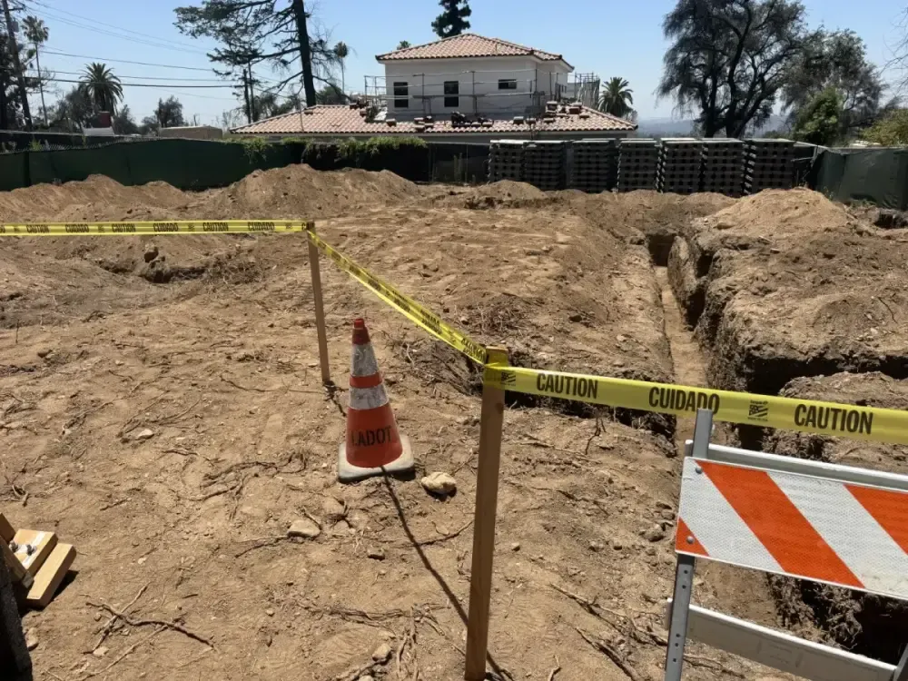 Sump pump and water service utility box at an Altadena East Palm Avenue fire rebuild, used only when gravity drainage is not possible
