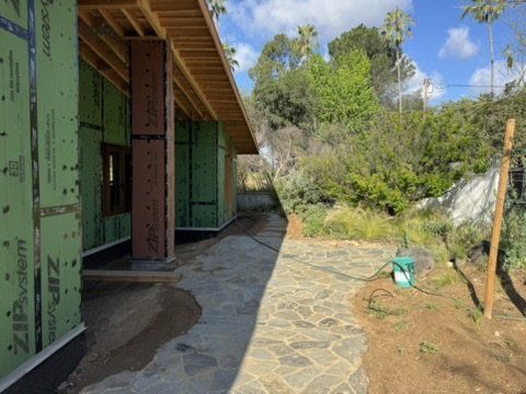 Altadena home under construction showing ZIP System sheathing and flagstone walkway with drainage design