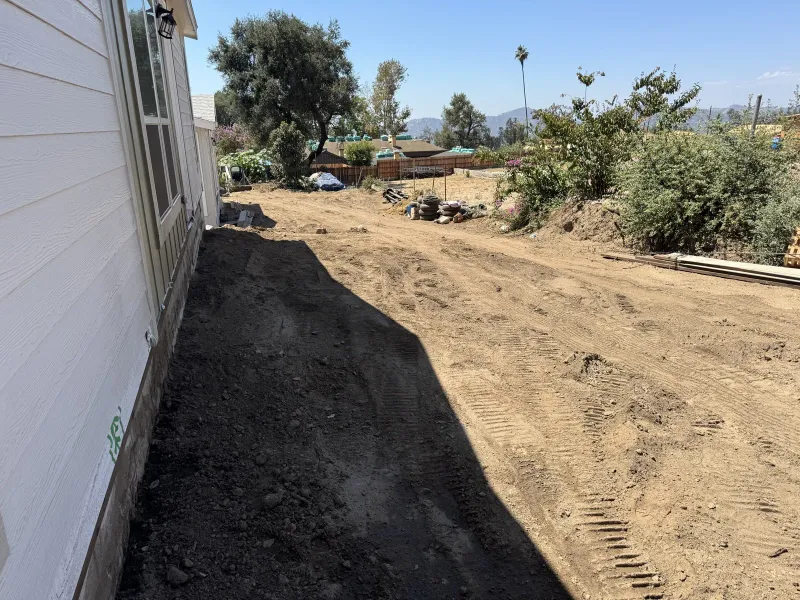 Freshly graded bare dirt lot in Altadena during an early-stage Eaton Fire rebuild on Las Flores Drive