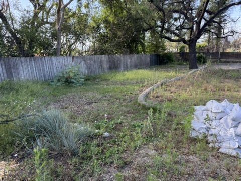 Altadena lot with erosion control wattle and sandbags ready for residential rebuild