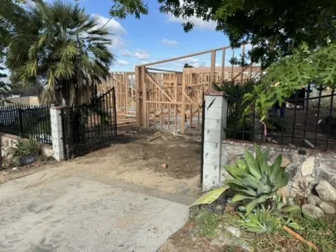 New home with gated entrance and 1,325-gallon underground fire protection tank at an Altadena Marengo Avenue fire rebuild drainage project