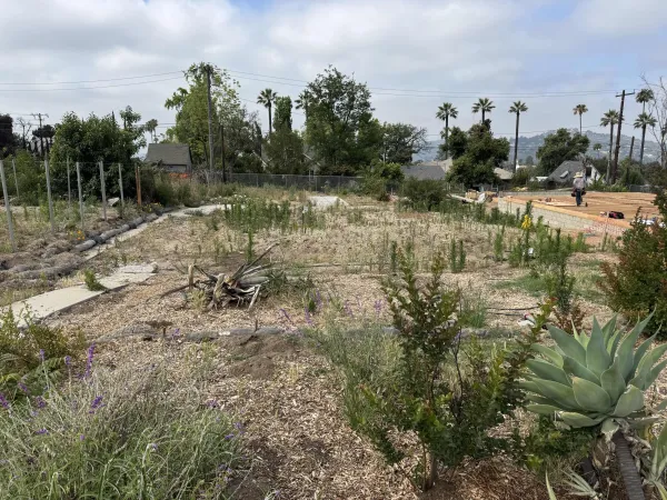 Construction site overview showing prepared building pad and drainage routing for Altadena fire rebuild