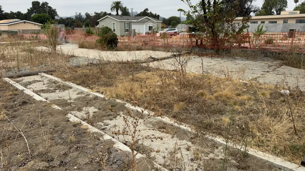 Cleared Altadena fire rebuild lot on W Mendocino Ave with concrete foundation strips remaining after Eaton Fire demolition, prepped for grading and drainage design