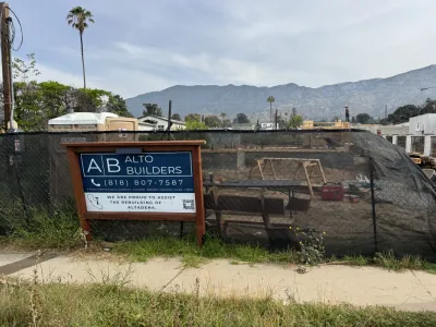 Pre-construction Altadena fire rebuild lot with Alto Builders sign and mountain views