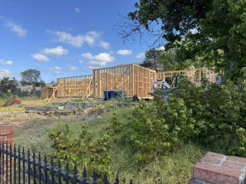 Wooden framing of new Altadena residence on sloped lot requiring drainage plan with underground tank