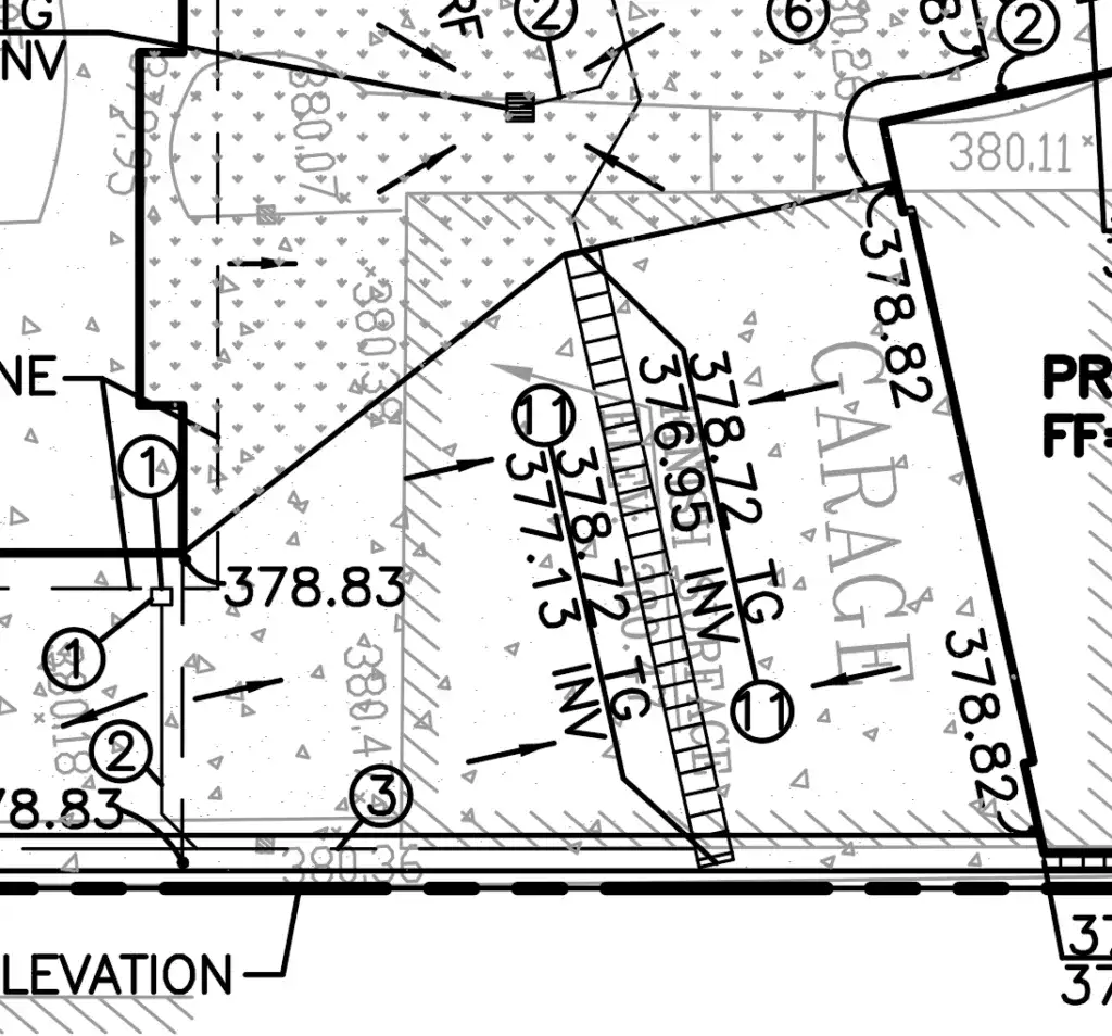 Civil engineering grading plan drawing for a garage area, showing spot elevations, drainage flow arrows, and top of grade markers