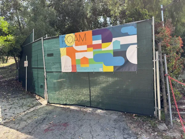 Construction site perimeter with fencing and erosion control