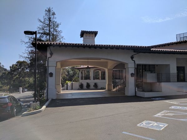 Spanish-style Chevy Chase Country Club porte-cochère with accessible parking lot and proper drainage