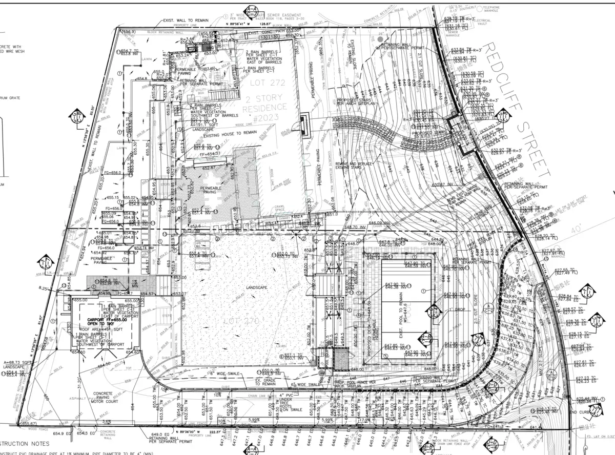 Civil engineering site plan showing grading details for a hillside residential property with contour lines, spot elevations, retaining walls, and drainage elements