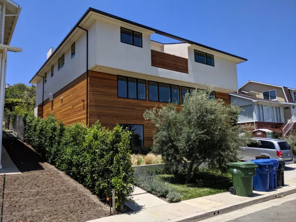 Three-story contemporary home on Marquez Terrace showing completed grading and landscaping