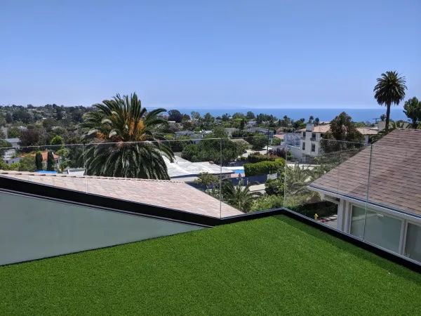 Rooftop turf with palm tree and ocean view at Marquez Terrace
