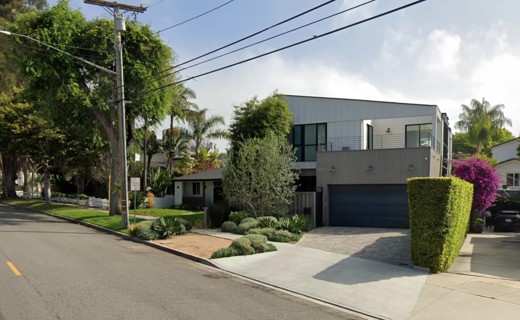 Redondo Beach Completed Project - Modern two-story residence with metal siding, wood slat cladding, xeriscaping, and paver driveway in established neighborhood