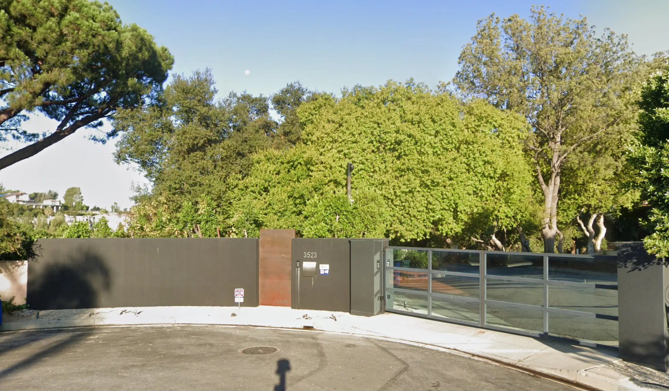 Studio City Completed Project - Modern residential entrance with charcoal grey perimeter wall, Corten steel accent, security gate, and mature landscaping